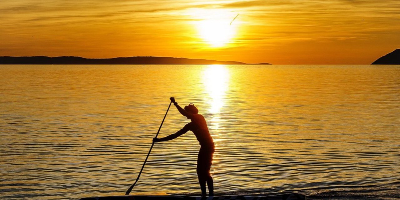 paddling with a sunset in background
